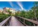 Wooden boardwalk path leading to community buildings at 1545 Citrine Trl, Tarpon Springs, FL 34689