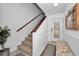 Bright entryway with staircase, bench, and white wainscoting at 1545 Citrine Trl, Tarpon Springs, FL 34689