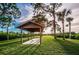 Wooden gazebo in a lush green park at 1545 Citrine Trl, Tarpon Springs, FL 34689