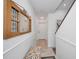 Light-filled hallway with decorative mirror and built-in bench at 1545 Citrine Trl, Tarpon Springs, FL 34689