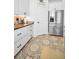 White kitchen with stainless steel appliances and wood countertops at 1545 Citrine Trl, Tarpon Springs, FL 34689