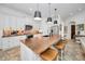 Modern kitchen boasts white cabinets, wood countertops, and mosaic tile flooring at 1545 Citrine Trl, Tarpon Springs, FL 34689