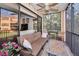Relaxing screened lanai with seating area, ceiling fan, and tranquil outdoor view at 1545 Citrine Trl, Tarpon Springs, FL 34689