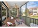 Screened lanai with seating area, overlooking the community at 1545 Citrine Trl, Tarpon Springs, FL 34689