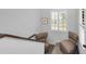 Upstairs landing with two comfortable chairs and natural light at 1545 Citrine Trl, Tarpon Springs, FL 34689