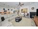 Spacious living room with sectional sofa, fireplace, and large artwork at 1545 Citrine Trl, Tarpon Springs, FL 34689