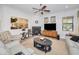 Bright and airy living room with a cozy fireplace and ample seating at 1545 Citrine Trl, Tarpon Springs, FL 34689