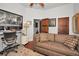 Spacious home office with large artwork, comfortable sofa, and built-in shelving at 1545 Citrine Trl, Tarpon Springs, FL 34689