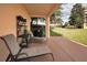 Covered patio with lounge chairs and grill at 1545 Citrine Trl, Tarpon Springs, FL 34689