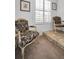 Sitting area featuring two unique chairs and a decorative floor at 1545 Citrine Trl, Tarpon Springs, FL 34689