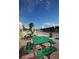 Green picnic tables line a street in Tarpon Springs at 1545 Citrine Trl, Tarpon Springs, FL 34689