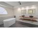 Elegant bathroom with double sinks,freestanding bathtub, and modern finishes at 15806 Adobe Dr, Hudson, FL 34667