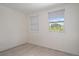 Bright bedroom with wood-look floors and two windows at 15806 Adobe Dr, Hudson, FL 34667