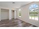 Bedroom with arched windows, wood-look floors, and a closet at 15806 Adobe Dr, Hudson, FL 34667