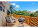 Relaxing deck with grill and seating area, enjoying a treetop view at 15806 Adobe Dr, Hudson, FL 34667