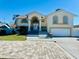 Two-story house with a large driveway and landscaping at 15806 Adobe Dr, Hudson, FL 34667