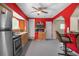Bright kitchen with wood cabinets, stainless steel appliances and red painted walls at 15806 Adobe Dr, Hudson, FL 34667