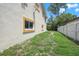 Side yard with grassy area and privacy fence at 15806 Adobe Dr, Hudson, FL 34667