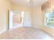 Spacious bedroom with tiled floors and access to other rooms at 2476 Silkwood Ct, Spring Hill, FL 34606