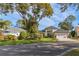 Two-story house with a red-trimmed garage and manicured lawn at 2476 Silkwood Ct, Spring Hill, FL 34606