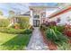 Inviting front entry with double doors and attractive landscaping at 2476 Silkwood Ct, Spring Hill, FL 34606