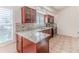 Kitchen boasts granite countertops and wood cabinets at 2476 Silkwood Ct, Spring Hill, FL 34606