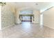 Spacious living room featuring a vaulted ceiling and tile flooring at 2476 Silkwood Ct, Spring Hill, FL 34606