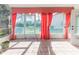 Bright sunroom with pink curtains and view of backyard at 2476 Silkwood Ct, Spring Hill, FL 34606