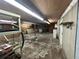 Unfinished basement area with concrete flooring and shelving at 3234 Ella Ln, New Port Richey, FL 34655