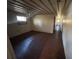 Spacious bedroom with dark wood-look flooring and a window at 3234 Ella Ln, New Port Richey, FL 34655