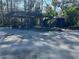 Covered parking area with a small shed and landscaping at 3234 Ella Ln, New Port Richey, FL 34655