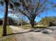 Long driveway leading to a home nestled amongst trees at 3234 Ella Ln, New Port Richey, FL 34655