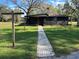 House exterior with brick walkway and lush green lawn at 3234 Ella Ln, New Port Richey, FL 34655