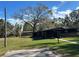 Single story home with large oak tree and grassy yard at 3234 Ella Ln, New Port Richey, FL 34655