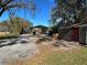 Property with multiple storage sheds and a gravel driveway at 3234 Ella Ln, New Port Richey, FL 34655