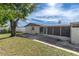 Backyard view showing a screened patio and grassy area at 3337 Darlington Rd, Holiday, FL 34691