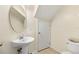 Simple bathroom with pedestal sink and toilet at 6334 Timberly Ln, Zephyrhills, FL 33542