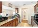 Kitchen with granite countertops, stainless steel appliances, and a view of a half-bath at 6334 Timberly Ln, Zephyrhills, FL 33542
