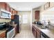 Well-lit kitchen with granite countertops, stainless steel appliances, and ample cabinet space at 6334 Timberly Ln, Zephyrhills, FL 33542