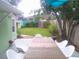 Outdoor patio area with table and chairs, and a large backyard at 641 Wilkie St, Dunedin, FL 34698