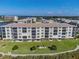 Aerial view highlighting condo building's waterfront location and lawn at 8150 Brent St # 746, Port Richey, FL 34668