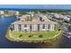 Aerial perspective of a waterfront condo complex with lush landscaping at 8150 Brent St # 746, Port Richey, FL 34668