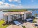 Aerial view of waterfront condo building with parking and water access at 8150 Brent St # 746, Port Richey, FL 34668