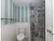 Bathroom with striped walls and walk-in shower at 8150 Brent St # 746, Port Richey, FL 34668