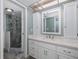 Clean bathroom with white cabinets and a large mirror at 8150 Brent St # 746, Port Richey, FL 34668