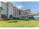 Condo building with parking and tropical landscaping at 8150 Brent St # 746, Port Richey, FL 34668