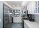 Modern kitchen with stainless steel appliances and white cabinets at 8150 Brent St # 746, Port Richey, FL 34668