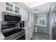 Modern kitchen with stainless steel appliances and white cabinets at 8150 Brent St # 746, Port Richey, FL 34668