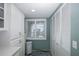 Bright laundry room with white cabinets and window at 8150 Brent St # 746, Port Richey, FL 34668