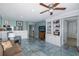 Bright living room with tile floors, built-in shelving, and comfortable seating at 8150 Brent St # 746, Port Richey, FL 34668